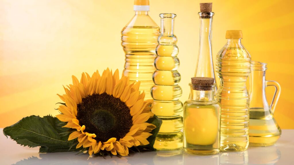 Premium sunflower oil bottles from Berkat Madinah, available in 1-liter and 5-liter sizes for cooking.