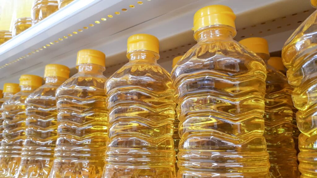 Premium sunflower oil bottles from Berkat Madinah, available in 1-liter and 5-liter sizes for cooking.